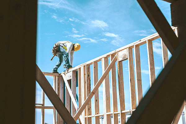 Construction workers building with mass timber